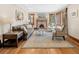 Comfortable living room featuring a fireplace, hardwood floors, and ample seating at 2591 Albion St, Denver, CO 80207