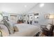 Bright main bedroom features vaulted ceilings, natural light, and access to a private balcony through sliding glass doors at 2591 Albion St, Denver, CO 80207