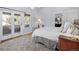 Bright bedroom with a private balcony, large windows, and a neutral color palette at 2591 Albion St, Denver, CO 80207