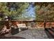 Inviting stone patio features a built-in grill, comfortable seating, and a privacy fence for relaxing outdoor gatherings at 2591 Albion St, Denver, CO 80207