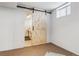 Laundry area with washer, dryer, and sink, and barn door at 3151 S Corona St, Englewood, CO 80113