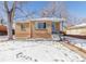 Brick ranch home with snow-covered yard and walkway at 3151 S Corona St, Englewood, CO 80113