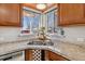 Bright kitchen features a corner sink, ample cabinetry, and a view from a large window at 3151 S Corona St, Englewood, CO 80113