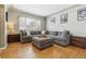 Spacious living room featuring hardwood floors and a sectional sofa at 3151 S Corona St, Englewood, CO 80113