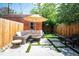 Charming backyard with patio, artificial turf, lounge seating, and privacy fence perfect for relaxing and entertaining at 480 S Grant St, Denver, CO 80209