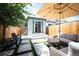 Charming backyard with patio, artificial turf, lounge seating, and privacy fence perfect for relaxing and entertaining at 480 S Grant St, Denver, CO 80209