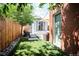 Charming backyard with patio, artificial turf, lounge seating, and privacy fence perfect for relaxing and entertaining at 480 S Grant St, Denver, CO 80209
