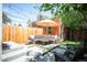 Charming backyard with patio, artificial turf, lounge seating, and privacy fence perfect for relaxing and entertaining at 480 S Grant St, Denver, CO 80209