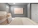 Clean finished basement bedroom featuring neutral decor, simple art, and an egress window at 480 S Grant St, Denver, CO 80209