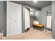 Clean finished basement features neutral decor, hardwood floors, a bench and ladder at 480 S Grant St, Denver, CO 80209