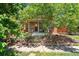 Charming brick home with a covered porch, mature trees, and inviting curb appeal at 480 S Grant St, Denver, CO 80209