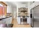 Well-lit kitchen with stainless steel appliances, granite countertops, and ample cabinet space, perfect for culinary enthusiasts at 480 S Grant St, Denver, CO 80209