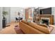 Open-concept living and dining area showcasing exposed brick, hardwood floors, and lots of natural light at 480 S Grant St, Denver, CO 80209