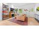 Bright living room featuring a fireplace, hardwood floors, and stylish decor with a view to the entry at 480 S Grant St, Denver, CO 80209