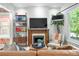 Comfortable living area with a fireplace, built-in shelves, and a large window with natural light at 480 S Grant St, Denver, CO 80209