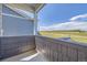 A view from the balcony overlooking a prairie, with cloudy skies overhead and modern architecture nearby at 2702 E 103Rd Ave, Thornton, CO 80229