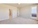 A cozy bedroom with neutral carpet and walls plus access to a private balcony at 2702 E 103Rd Ave, Thornton, CO 80229