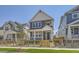 Charming two-story home with a covered front porch and a well-maintained lawn and decorative wood fence at 2702 E 103Rd Ave, Thornton, CO 80229