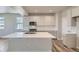 Modern kitchen with white cabinets, large island, and stainless steel appliances at 2702 E 103Rd Ave, Thornton, CO 80229