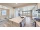 Open concept kitchen with a large island, stainless steel appliances, and modern finishes, flowing to living area at 2702 E 103Rd Ave, Thornton, CO 80229