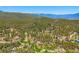 Stunning aerial view of homes nestled in a lush, forested area at 34075 Grouse Ln, Evergreen, CO 80439