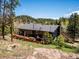 Home with a large deck, perfect for outdoor entertaining and relaxing surrounded by a lush forest at 34075 Grouse Ln, Evergreen, CO 80439