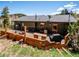 A large wooden deck with outdoor seating and a grill, perfect for summer BBQs at 34075 Grouse Ln, Evergreen, CO 80439