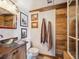 Bathroom with a vessel sink, wood accents, and rustic decor at 34075 Grouse Ln, Evergreen, CO 80439