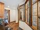 Rustic bathroom with wood trim windows and dark wood floors leading to the tile shower with stone-like design at 34075 Grouse Ln, Evergreen, CO 80439
