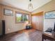 Bedroom with a closet, a large window overlooking a view, and brown engineered-wood flooring at 34075 Grouse Ln, Evergreen, CO 80439