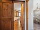 View from doorway to bedroom with bay window and wood floors with a sliding wooden door at 34075 Grouse Ln, Evergreen, CO 80439