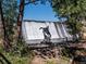Beautiful waterfall cascading from the dam with a statue of a rider on horseback in the foreground at 34075 Grouse Ln, Evergreen, CO 80439