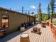 Inviting deck with string lights, seating and fire pit for outdoor enjoyment at 34075 Grouse Ln, Evergreen, CO 80439