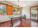 Inviting dining room features a large window, wood floors, and a striking chandelier at 34075 Grouse Ln, Evergreen, CO 80439