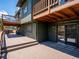 A spacious deck area featuring multiple levels and sliding glass doors to the home at 34075 Grouse Ln, Evergreen, CO 80439