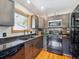 Kitchen features stainless steel appliances, black granite countertops, and a window view at 34075 Grouse Ln, Evergreen, CO 80439