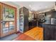 Modern kitchen with stainless steel appliances, wooden floors, and a view to the deck at 34075 Grouse Ln, Evergreen, CO 80439
