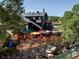 Charming restaurant with outdoor seating overlooking a rocky riverfront at 34075 Grouse Ln, Evergreen, CO 80439