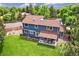 Aerial view of the backyard showcasing a covered patio, lush lawn, and outdoor seating area, perfect for entertaining at 13701 Yank Way, Arvada, CO 80004