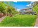 Spacious backyard featuring a lush lawn, wooden playground, and patio area for relaxation and entertainment at 13701 Yank Way, Arvada, CO 80004