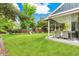 Lush backyard with well-maintained lawn, wooden fence, patio with seating and playground equipment at 13701 Yank Way, Arvada, CO 80004