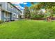 Expansive backyard featuring a lush lawn, enclosed patio, and playset offering ample space for recreation and relaxation at 13701 Yank Way, Arvada, CO 80004
