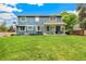 Well-maintained backyard showcases a covered patio, lush lawn, and inviting outdoor space for relaxation and entertainment at 13701 Yank Way, Arvada, CO 80004