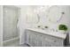 Luxurious bathroom with a double vanity, modern fixtures, stylish mirrors, and a sleek walk-in shower at 13701 Yank Way, Arvada, CO 80004