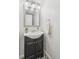 Charming bathroom features a modern vanity with stylish mirror and decorative patterned tile floor at 13701 Yank Way, Arvada, CO 80004