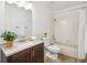 Bright bathroom with a modern vanity, neutral color palette, and wood-style floors at 13701 Yank Way, Arvada, CO 80004