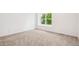 Bright bedroom with large window that lets in natural light and neutral carpet at 13701 Yank Way, Arvada, CO 80004