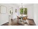 Dining room with hardwood floors, natural light, and modern chandelier at 13701 Yank Way, Arvada, CO 80004