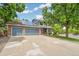 Charming two-story home featuring a spacious driveway, three-car garage, and well-manicured landscaping at 13701 Yank Way, Arvada, CO 80004
