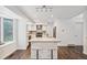 Bright kitchen features white cabinets, stainless appliances, and a center island with seating at 13701 Yank Way, Arvada, CO 80004